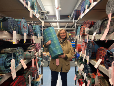 Picture of Rachael Hamilton MSP holding her family tartan, woven by Lochcarron, attached.